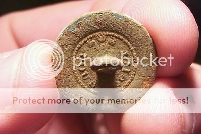 Welshplumesbackmarkbutton.jpg